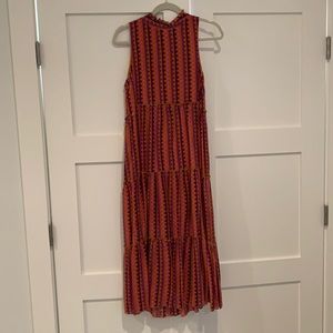 Sleeveless, ruffle neck. Keyhole back 3 tier dress